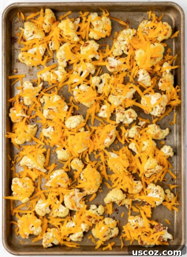 Golden Cheesy Roasted Cauliflower 15 adding cheese to the roasted cauliflower
