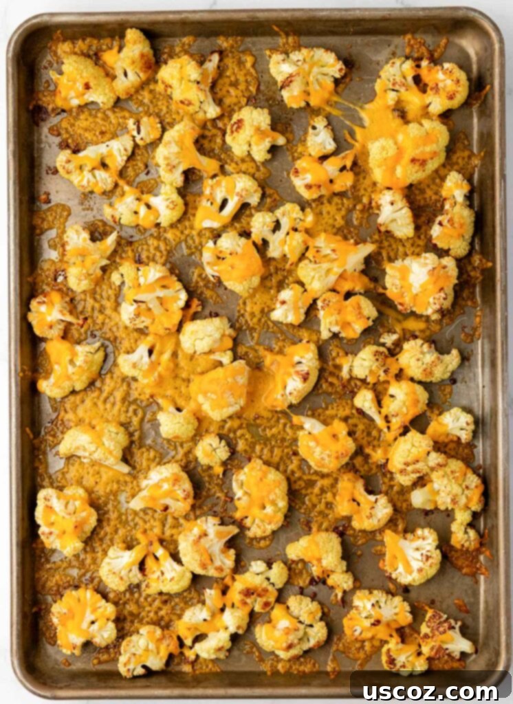 Golden Cheesy Roasted Cauliflower 16 roasted cauliflower with cheese on a baking sheet
