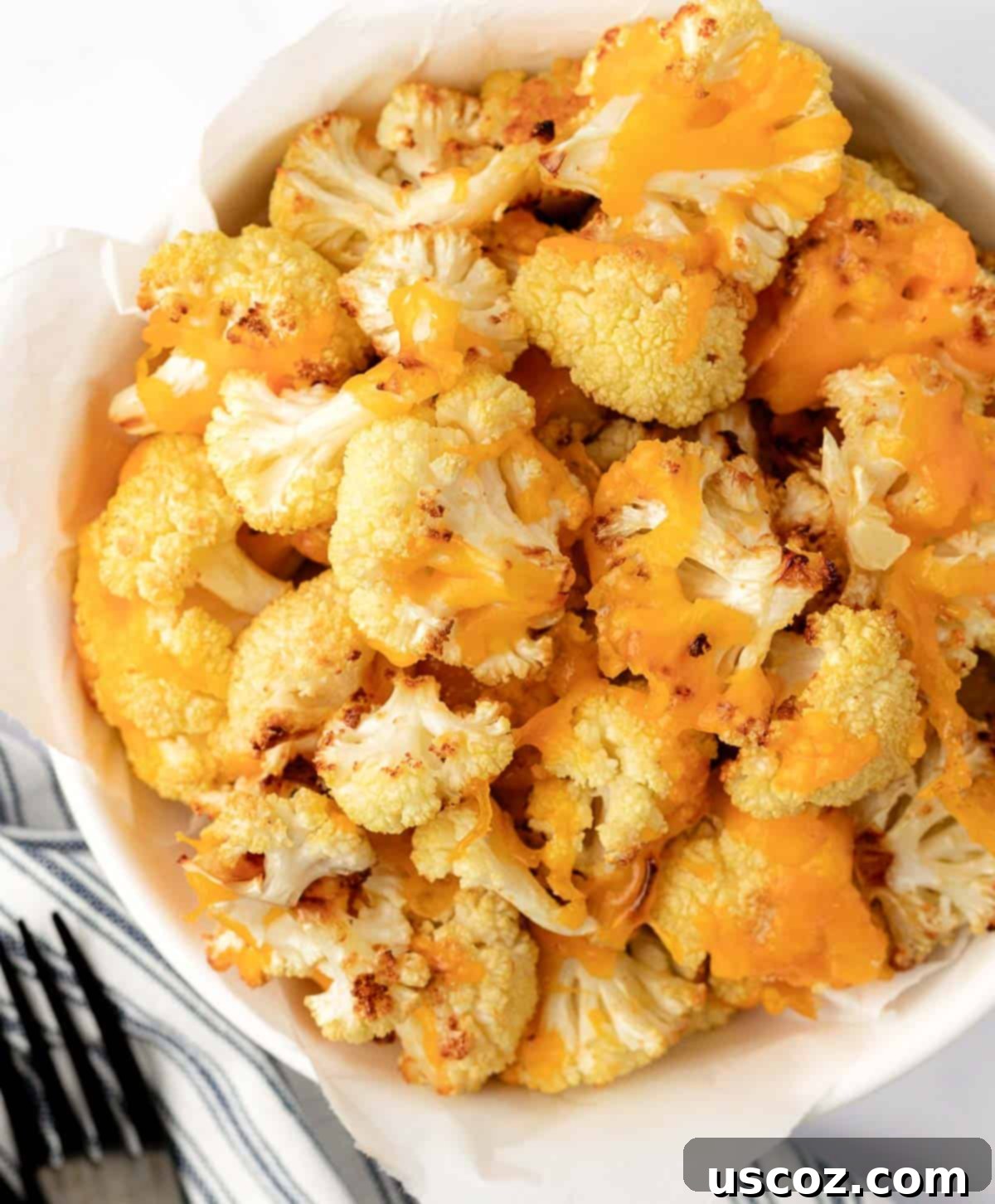 Golden Cheesy Roasted Cauliflower 17 cheesy cauliflower in a serving bowl