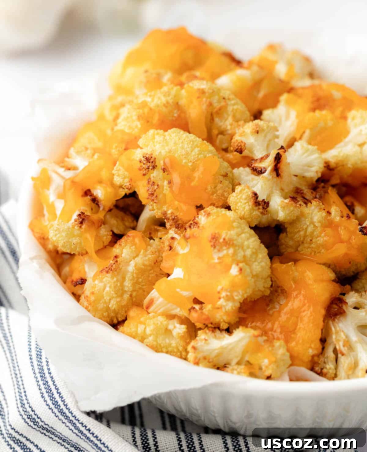 Golden Cheesy Roasted Cauliflower 19 cheesy cauliflower in a serving bowl