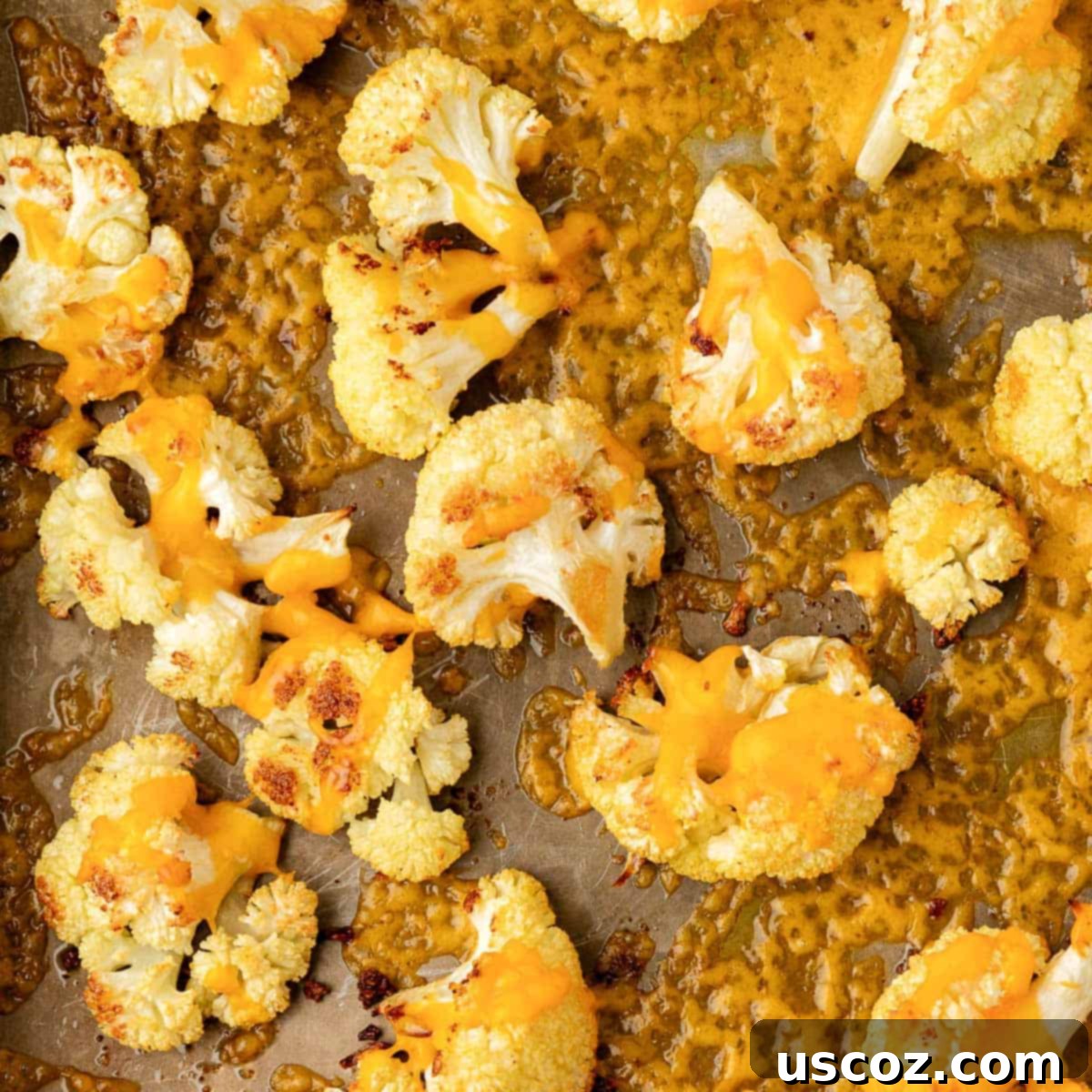 Golden Cheesy Roasted Cauliflower 20 roasted cauliflower with cheese on a baking sheet