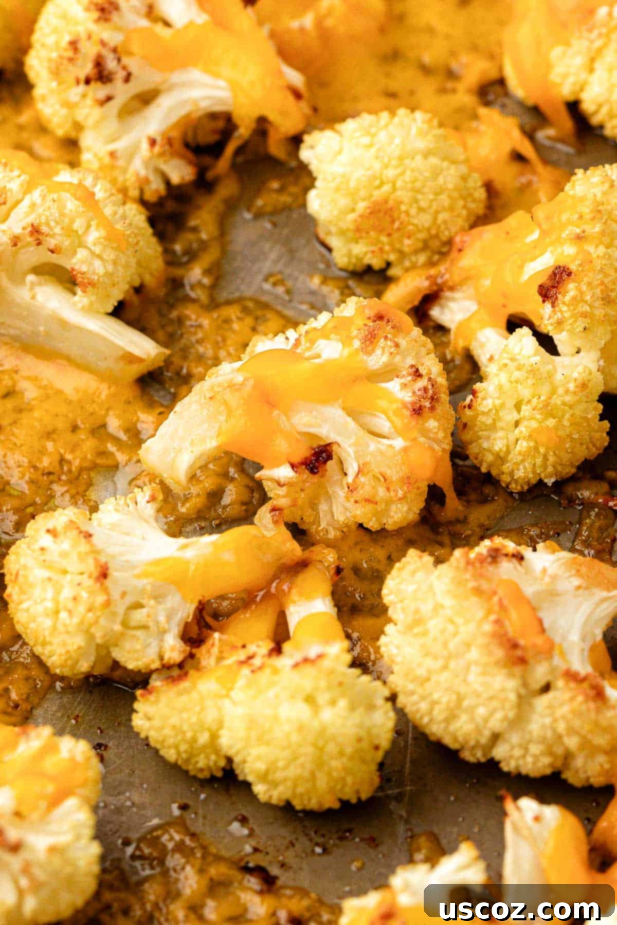Golden Cheesy Roasted Cauliflower 3 roasted cauliflower with cheese on a baking sheet