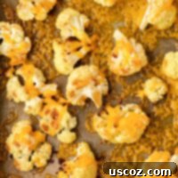 Golden Cheesy Roasted Cauliflower 21 roasted cauliflower with cheese on a baking sheet