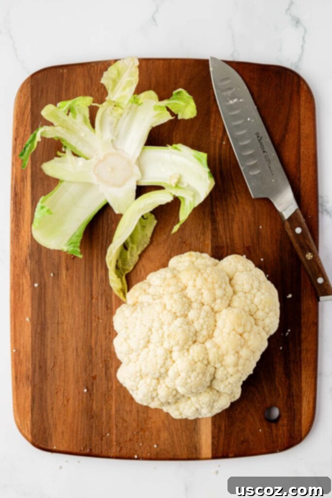 Golden Cheesy Roasted Cauliflower 5 cauliflower on a cutting board