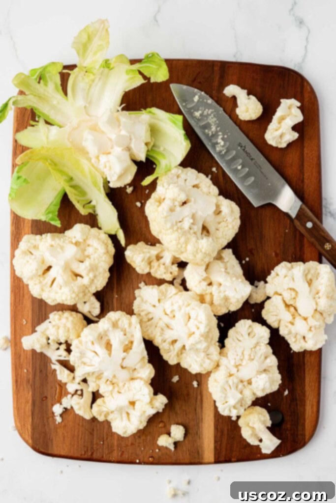 Golden Cheesy Roasted Cauliflower 6 cutting cauliflower on a cutting board