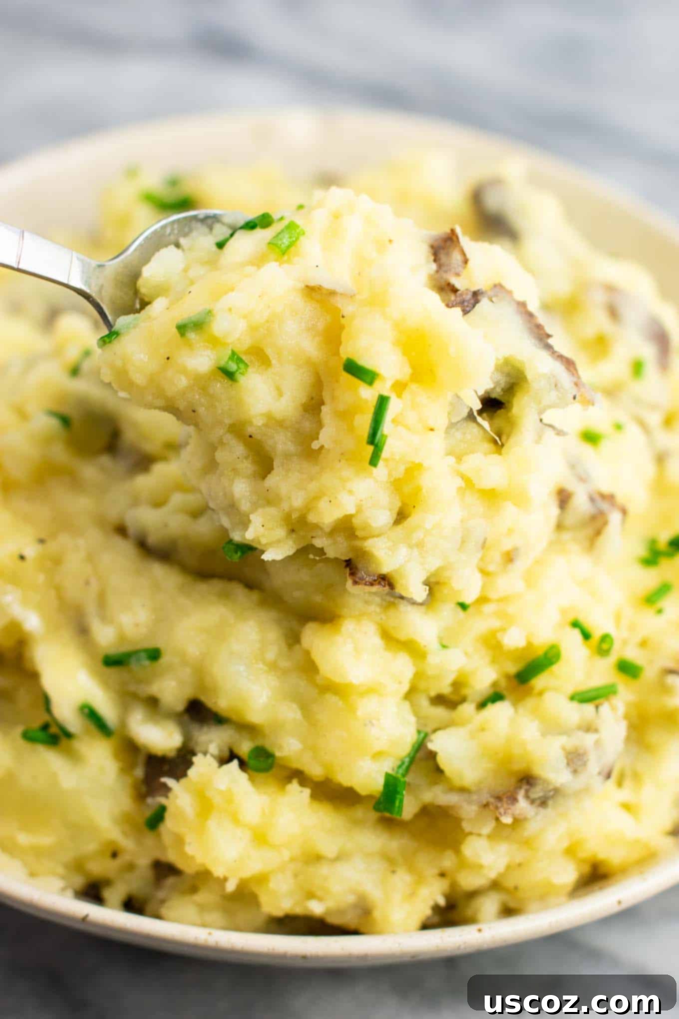 Creamy Vegan Mashed Potatoes 4 Close-up of perfectly mashed potatoes with finely chopped chives on top, showcasing the creamy texture.