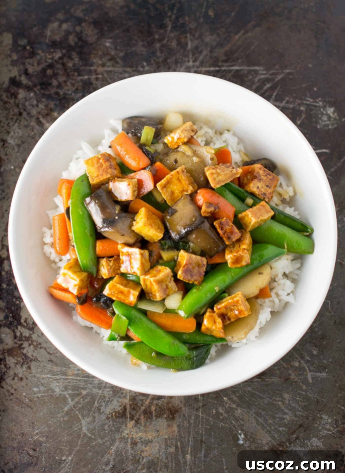 Golden Honey-Ginger Tofu Delight 4 Assortment of fresh stir fry ingredients including tofu, ginger, garlic, and colorful vegetables on a wooden cutting board