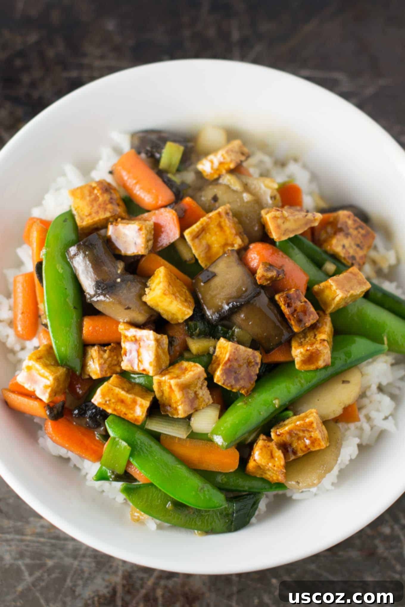 Golden Honey-Ginger Tofu Delight 6 Overhead shot of honey ginger tofu stir fry with rice in a large white serving bowl, ready to be enjoyed