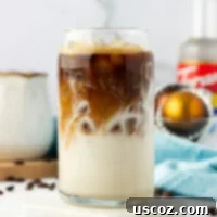 Silky Cold Espresso 12 A perfectly chilled iced latte in a tall glass, garnished with a straw, showcasing the creamy blend of coffee and milk.