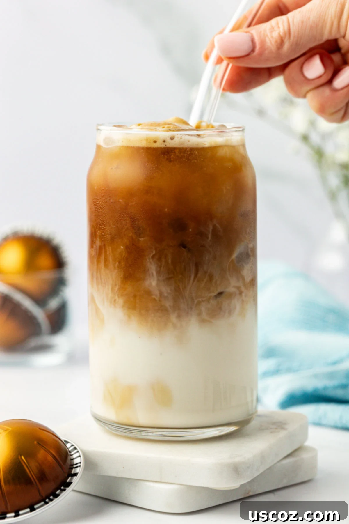 Silky Cold Espresso 9 A beautiful iced latte in a tall glass with a straw, ready to be enjoyed. The layers are subtly blended, and the drink looks perfectly chilled and refreshing.