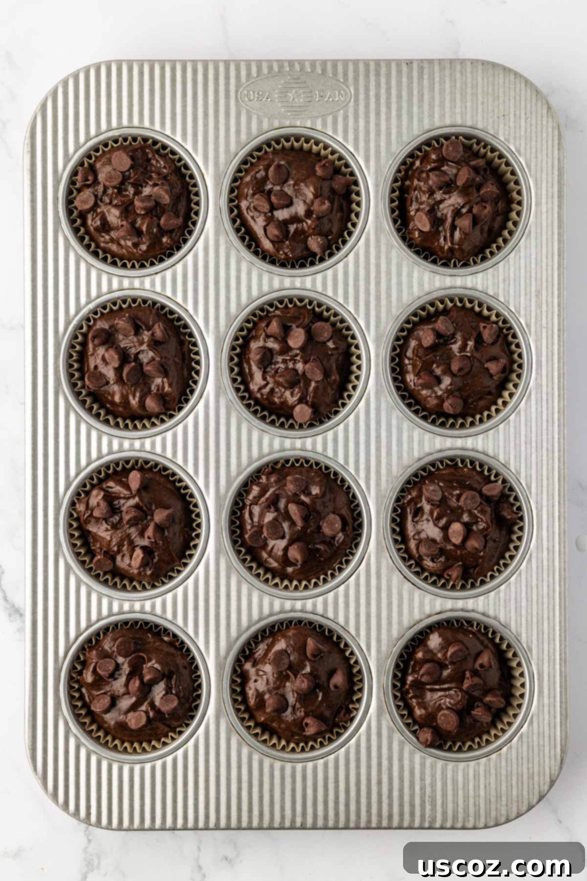 Irresistible Double Chocolate Cake Mix Muffins 11 muffin tin filled with cake mix batter, ready for the oven