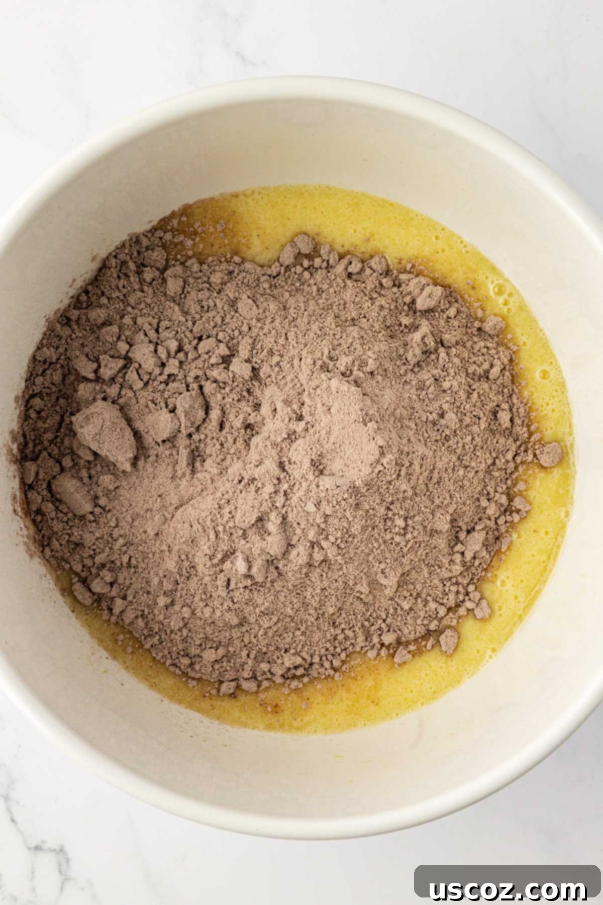 Irresistible Double Chocolate Cake Mix Muffins 7 adding chocolate cake mix to the batter