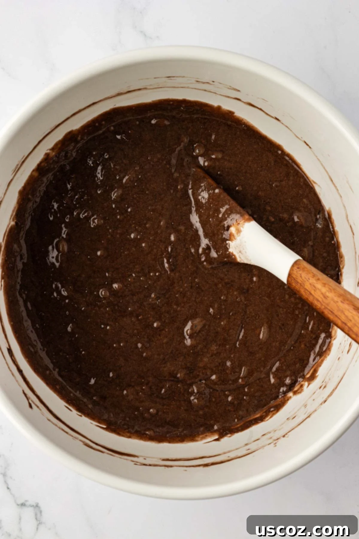Irresistible Double Chocolate Cake Mix Muffins 8 cake mix chocolate muffin batter in a mixing bowl, showing its thick consistency