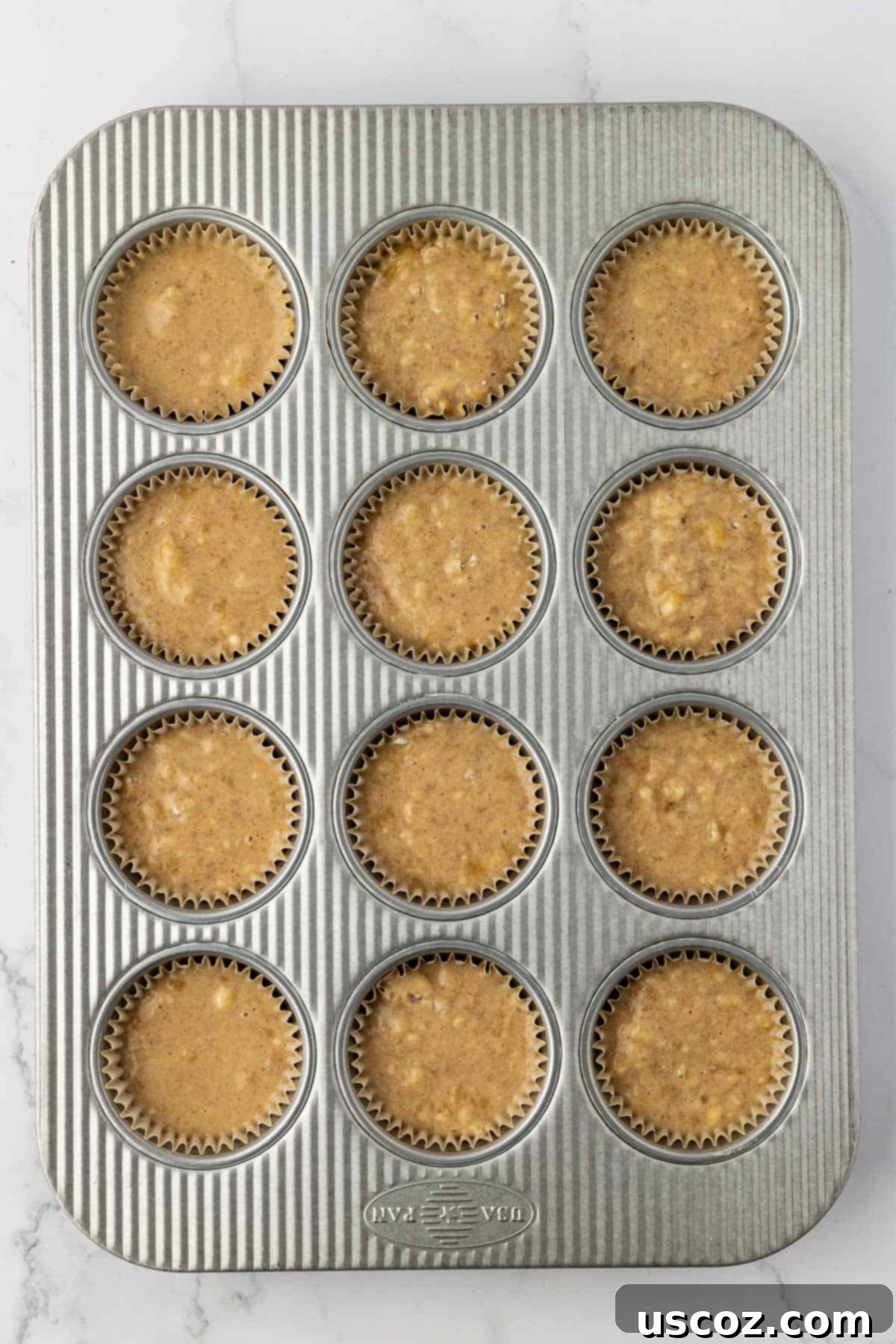 Deliciously Healthy Banana Muffins 12 muffin tin filled with batter