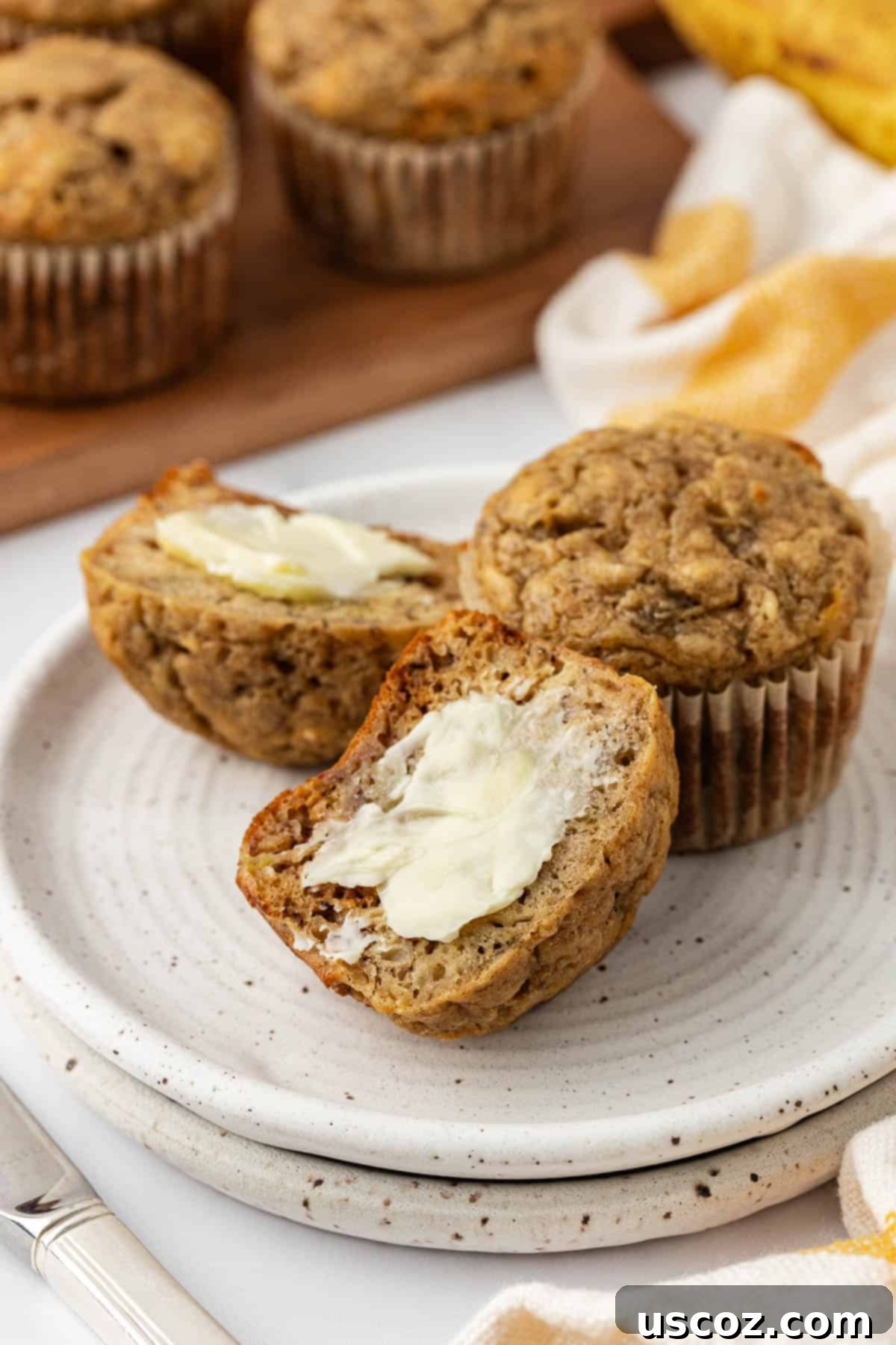 Deliciously Healthy Banana Muffins 3 banana muffin cut in half and topped with butter
