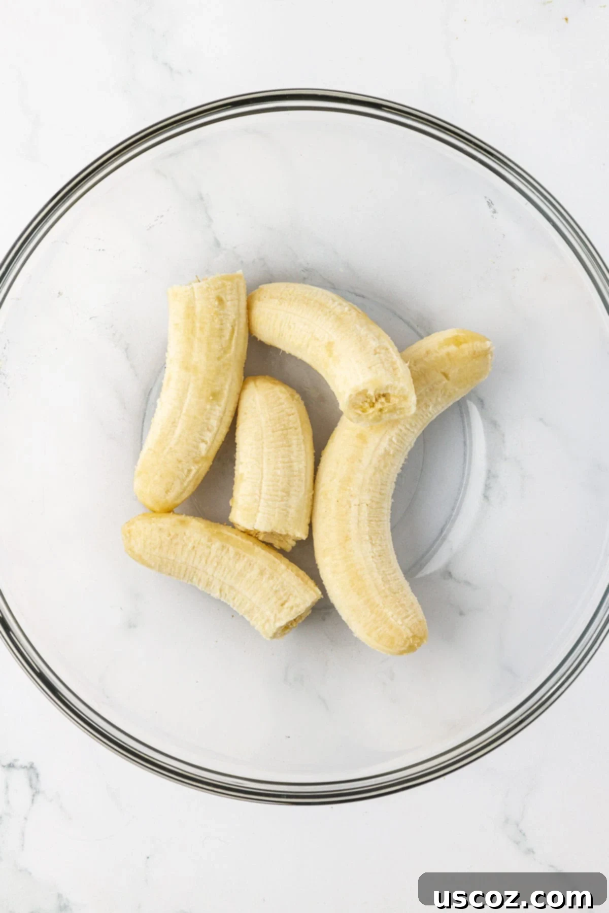 Deliciously Healthy Banana Muffins 5 ripe bananas in a mixing bowl