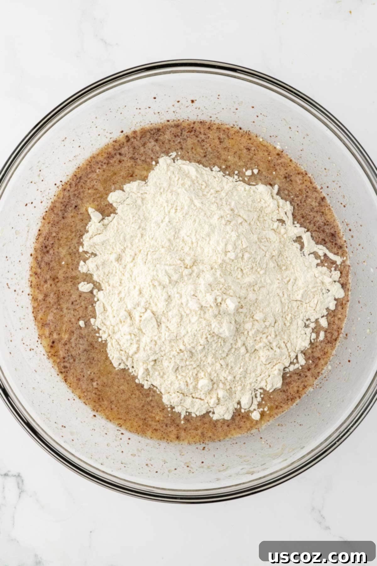 Deliciously Healthy Banana Muffins 9 adding the dry ingredients to the wet ingredients