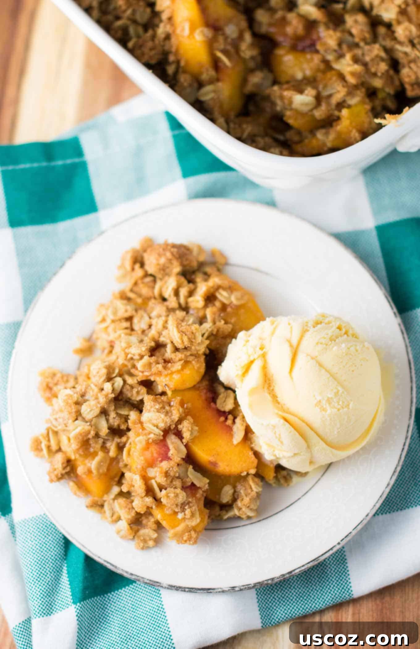 Delicious & Easy Peach Crisp 7 Close-up photo of a baked easy peach crisp, showing the bubbly filling and crunchy topping