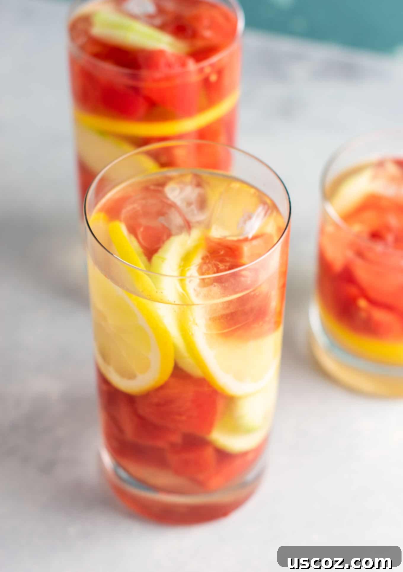 Hydrating Watermelon Detox Elixir 5 Individual serving of Watermelon Detox Water, garnished with fresh cucumber and lemon slices, ready to drink. Emphasizing its healthy and refreshing qualities.