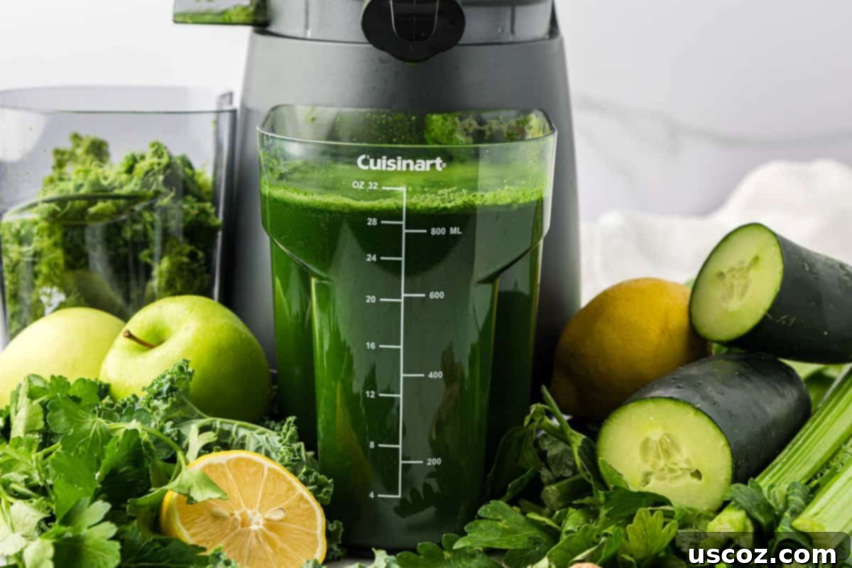Vital Veggie Boost 3 Green juice collecting in the juicer's canister, showing the fresh vibrant color.