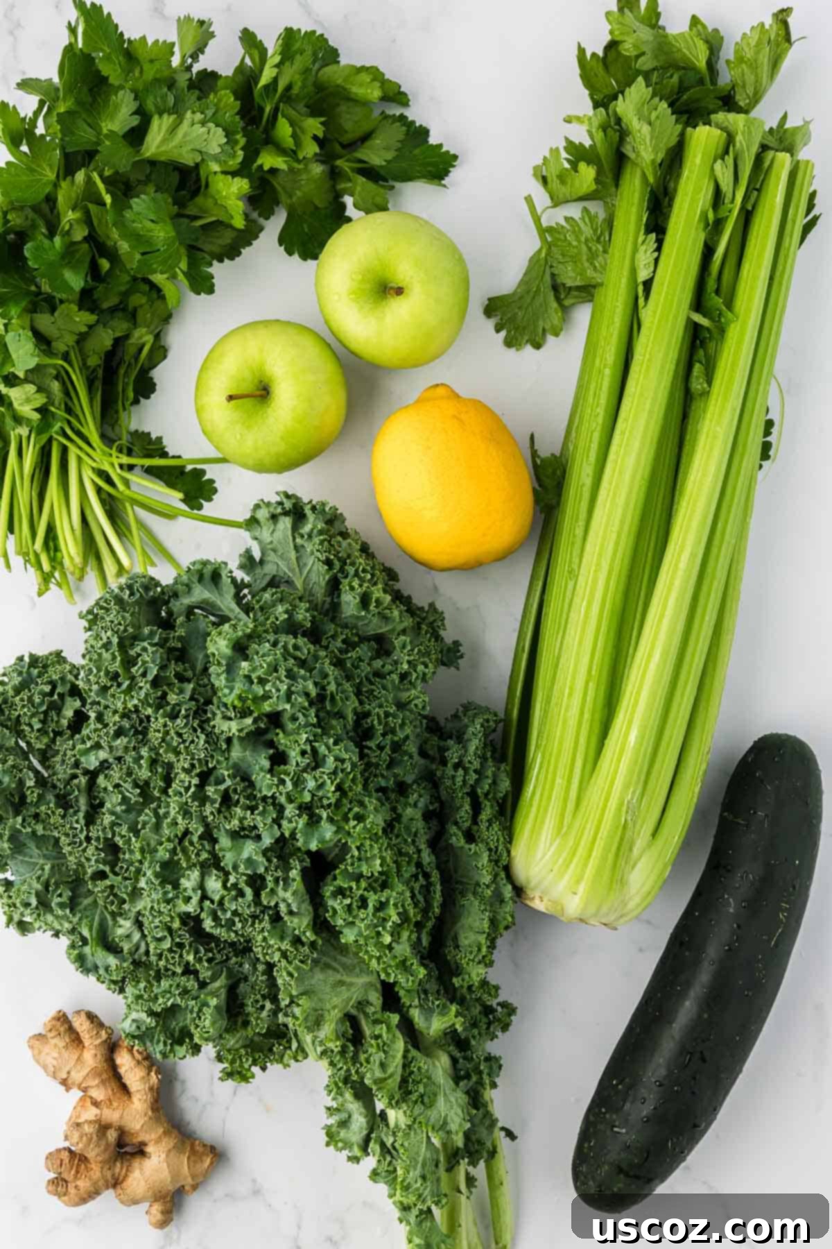 Vital Veggie Boost 4 A vibrant selection of fresh ingredients including cucumber, kale, parsley, green apples, lemon, celery, and ginger laid out, ready for juicing.