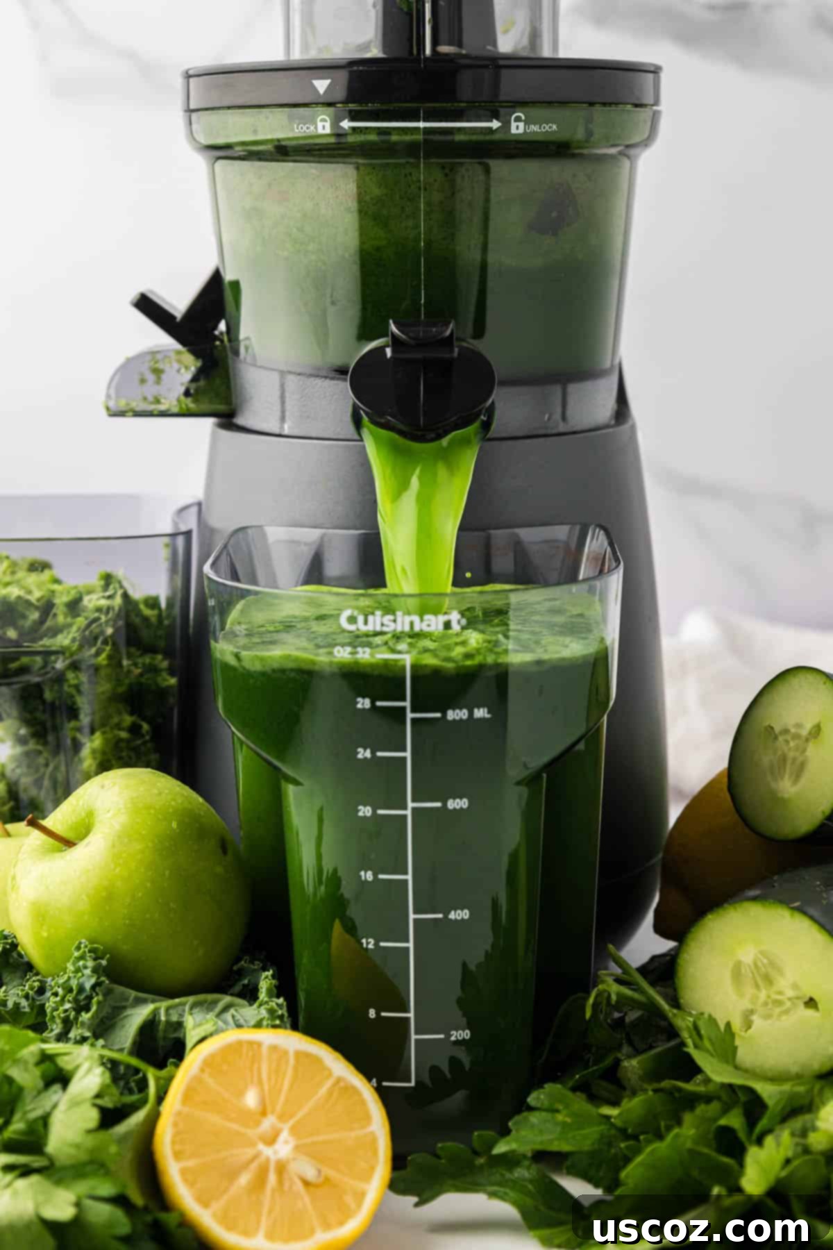Vital Veggie Boost 5 Close-up of green juice being extracted from a juicer into a collection pitcher.