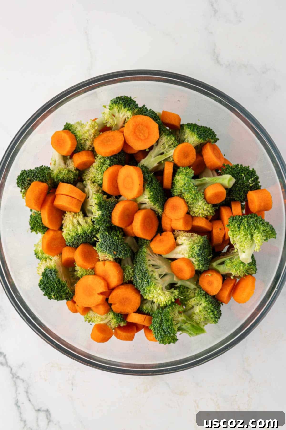 Crispy Roasted Broccoli and Carrots 5 broccoli florets and sliced carrots in a mixing bowl