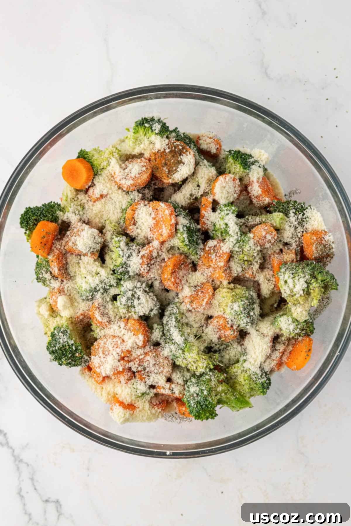 Crispy Roasted Broccoli and Carrots 6 broccoli, carrots, parmesan, oil, and spices in a mixing bowl