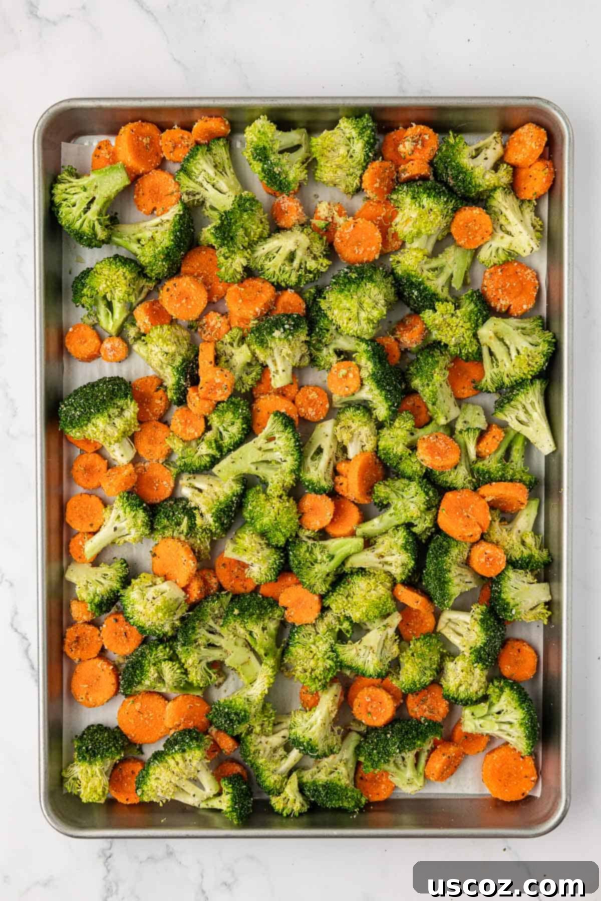 Crispy Roasted Broccoli and Carrots 8 sliced carrots and broccoli florets on a baking sheet