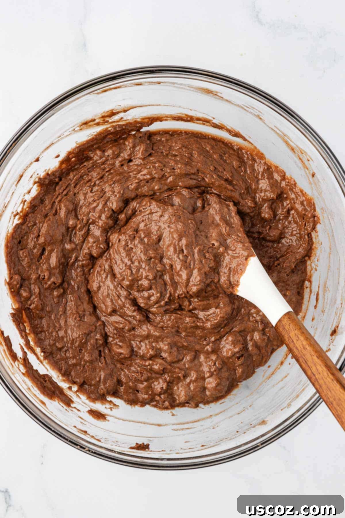 Guilt-Free Chocolate Mini Muffins 10 Healthy chocolate mini muffin batter after mixing, showing a slightly lumpy texture.