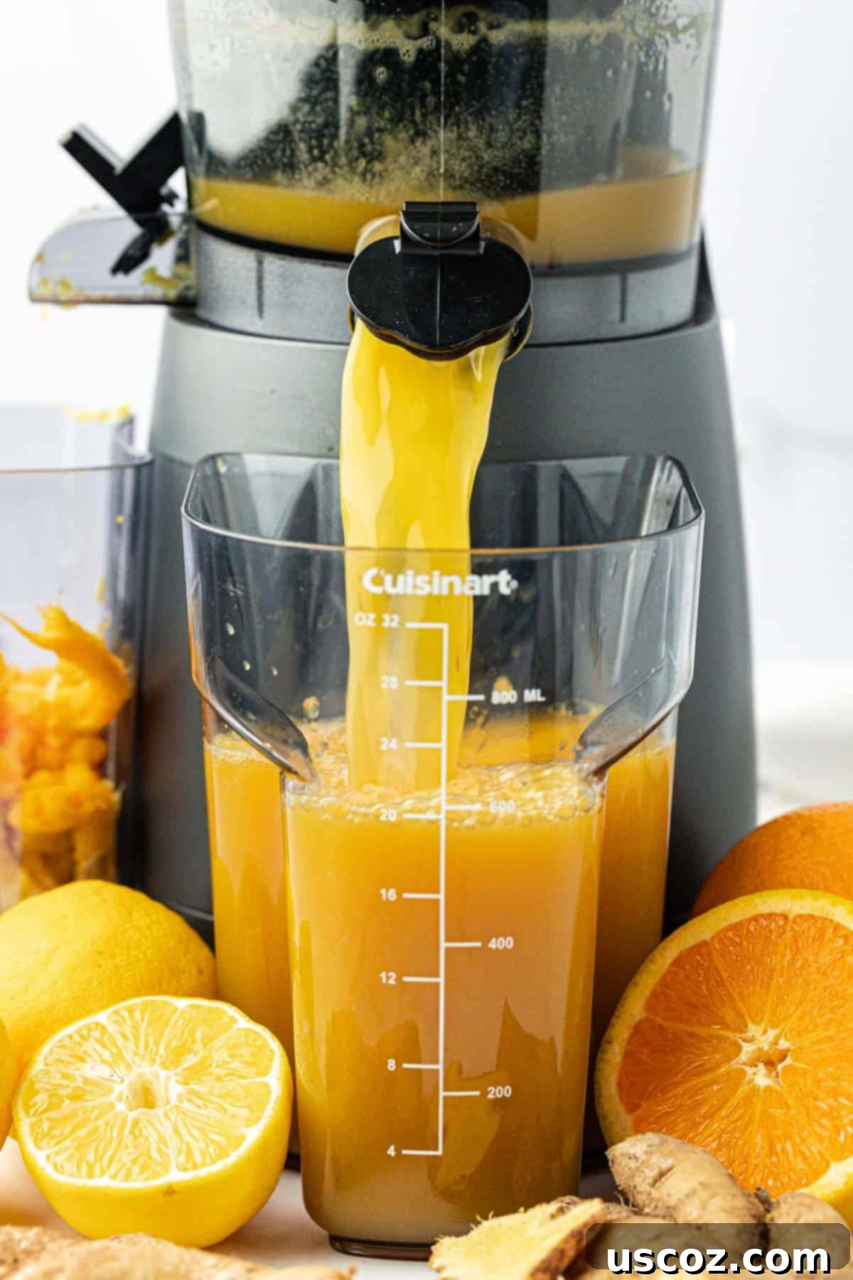 Immune Boost Shots 5 Pouring freshly squeezed orange, lemon, and ginger juice into small glass immunity shot bottles.