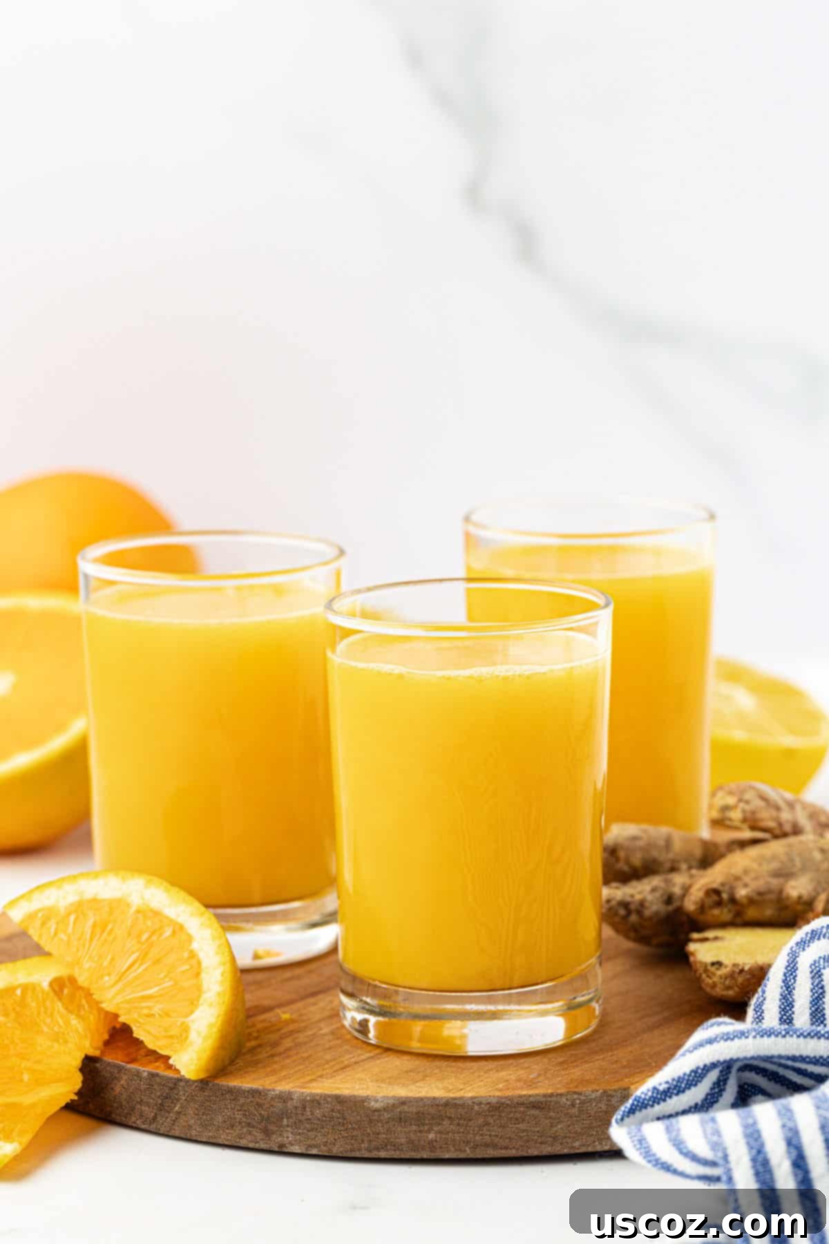 Immune Boost Shots 6 A small glass bottle filled with golden citrus ginger juice, labeled as an 'Immunity Shot'.