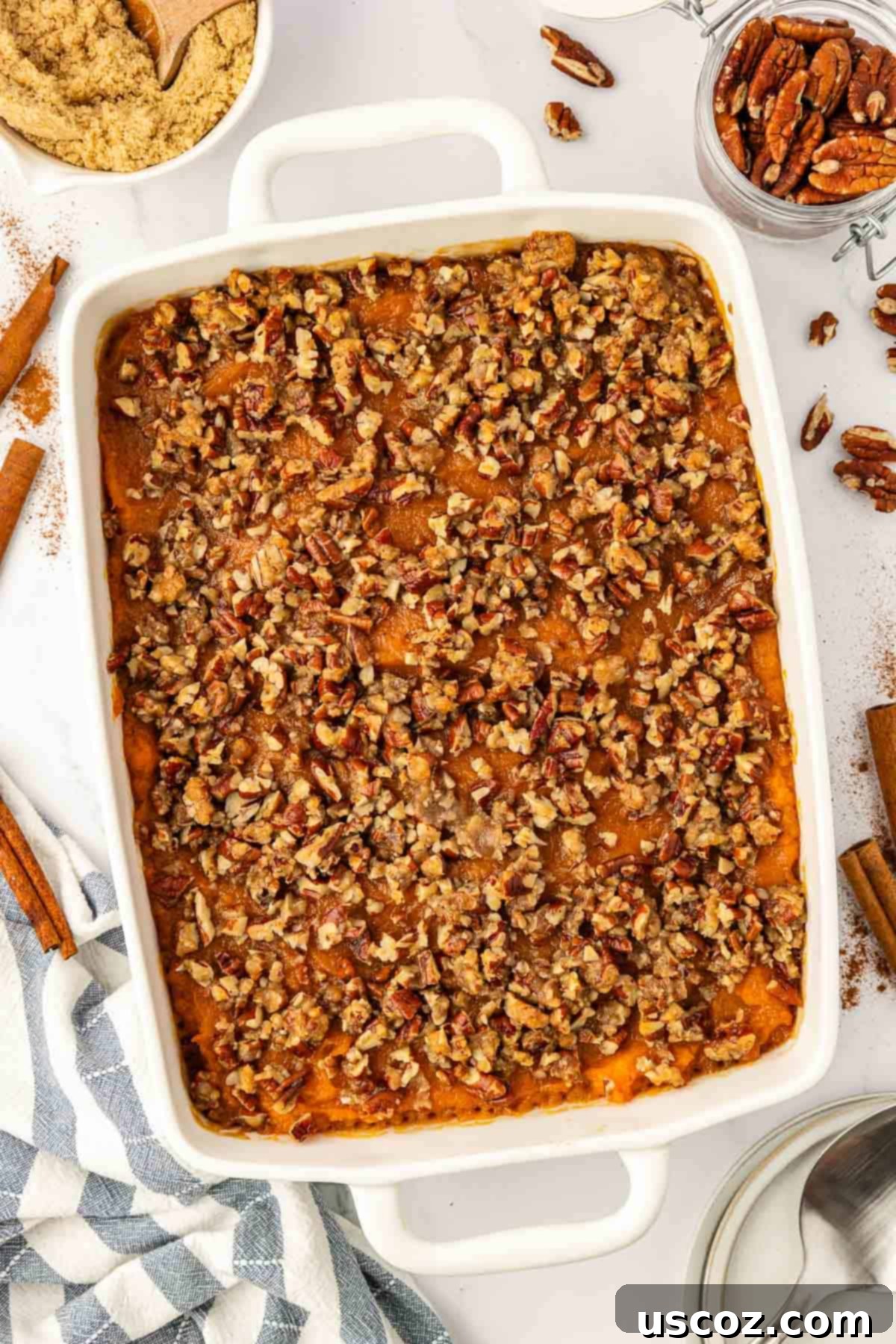 Golden Sweet Potato & Pecan Delight 2 Sweet potato casserole with a golden brown, irresistible pecan topping baked in a large dish, ready for holiday serving.