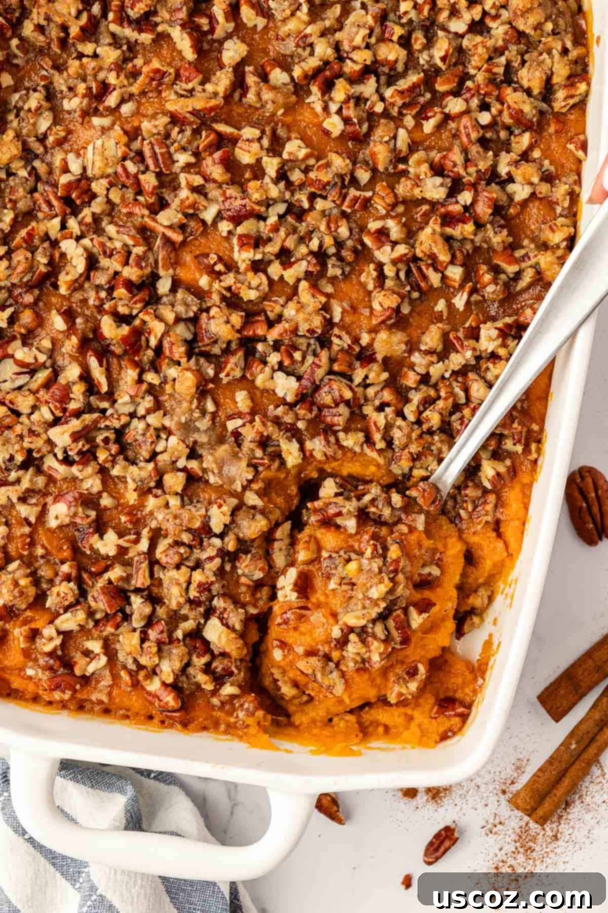 Golden Sweet Potato & Pecan Delight 15 A beautifully presented large baking dish of sweet potato casserole, featuring a perfectly golden and crisp pecan topping, ready to be served.