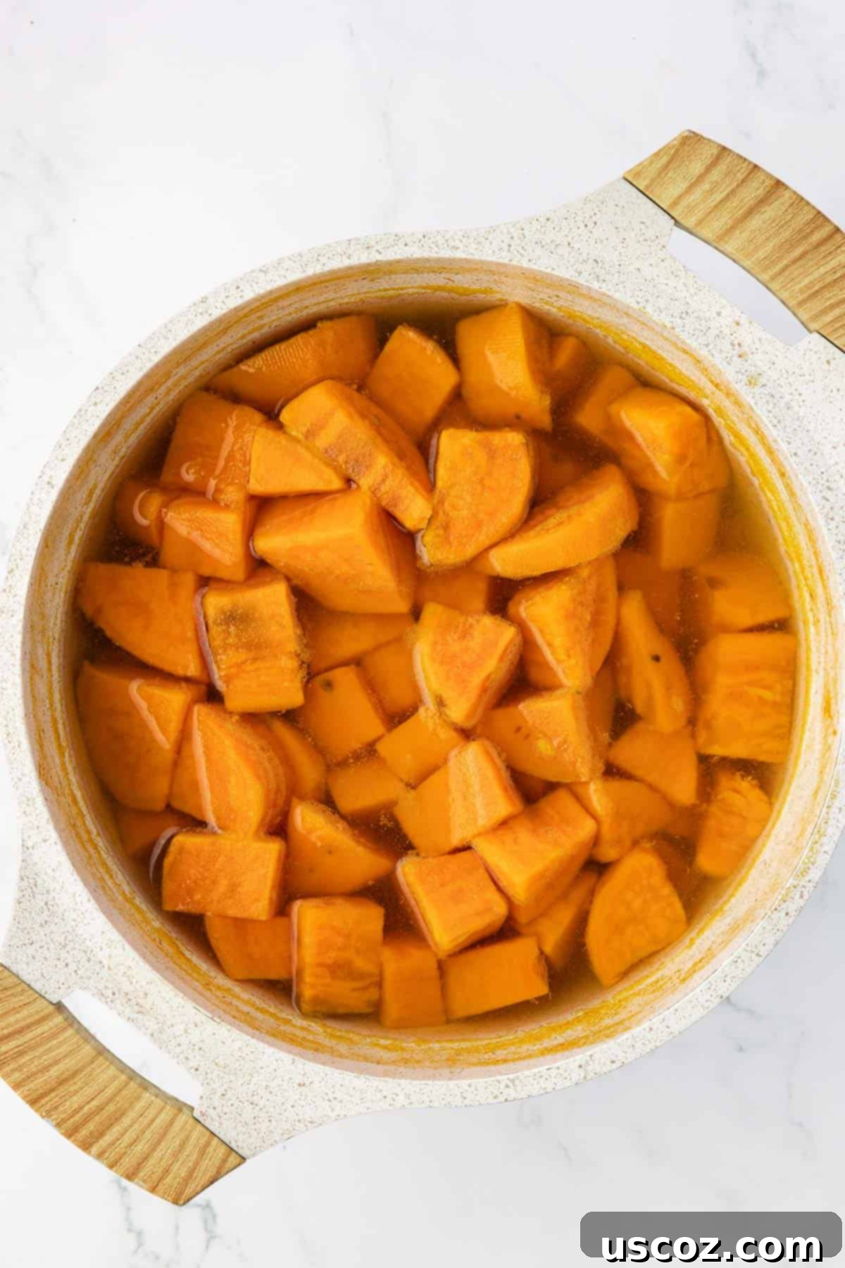Golden Sweet Potato & Pecan Delight 5 Close-up view of perfectly boiled and tender sweet potato chunks in a large saucepan, steaming and ready for mashing.