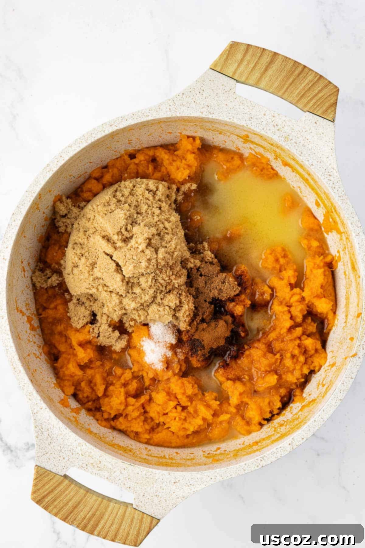 Golden Sweet Potato & Pecan Delight 7 Adding melted butter, rich brown sugar, and aromatic spices to the mashed sweet potatoes in a saucepan for the filling.