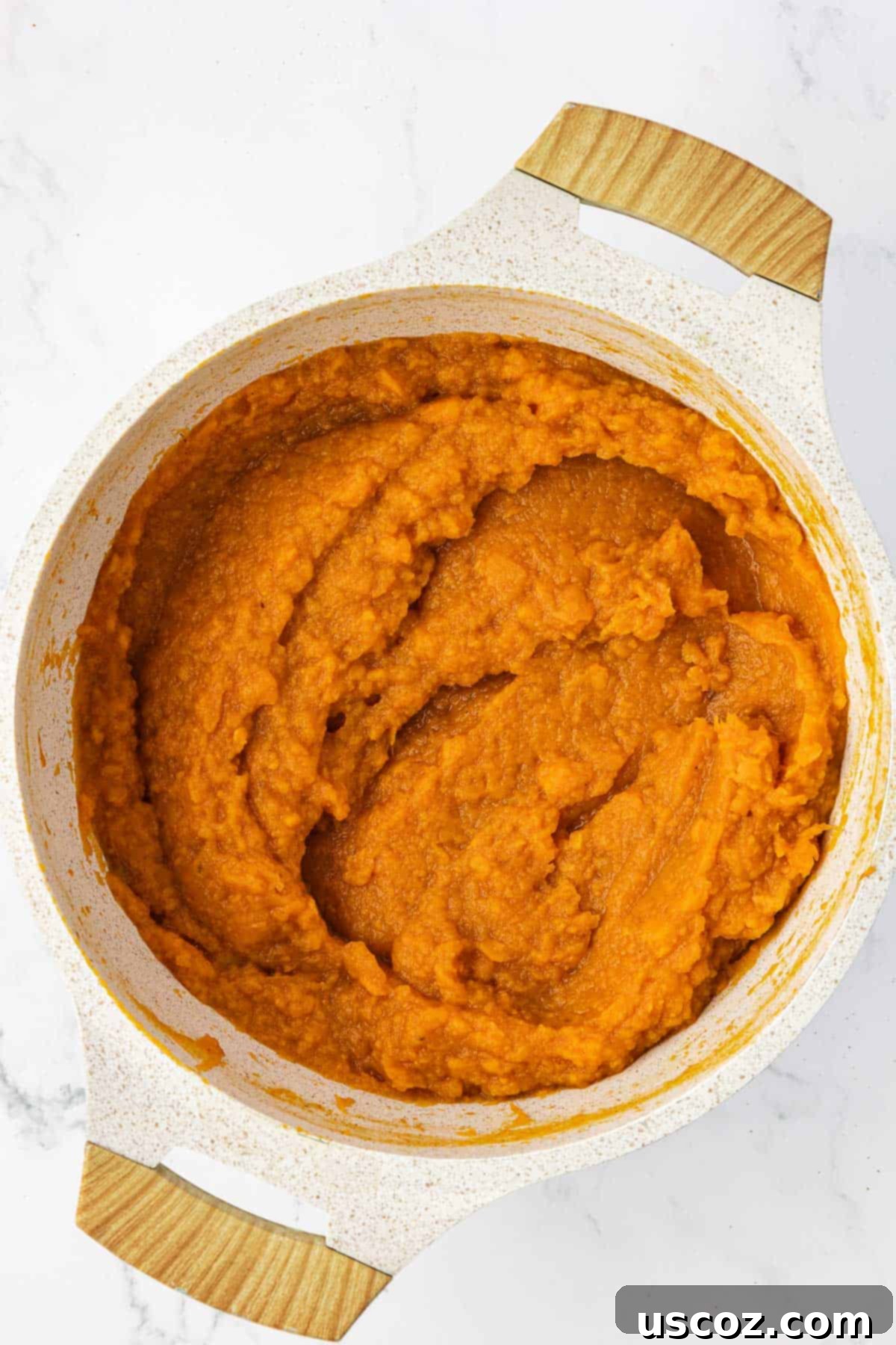Golden Sweet Potato & Pecan Delight 8 The smooth, perfectly mixed sweet potato casserole filling resting in a saucepan, vibrant and ready for assembly.