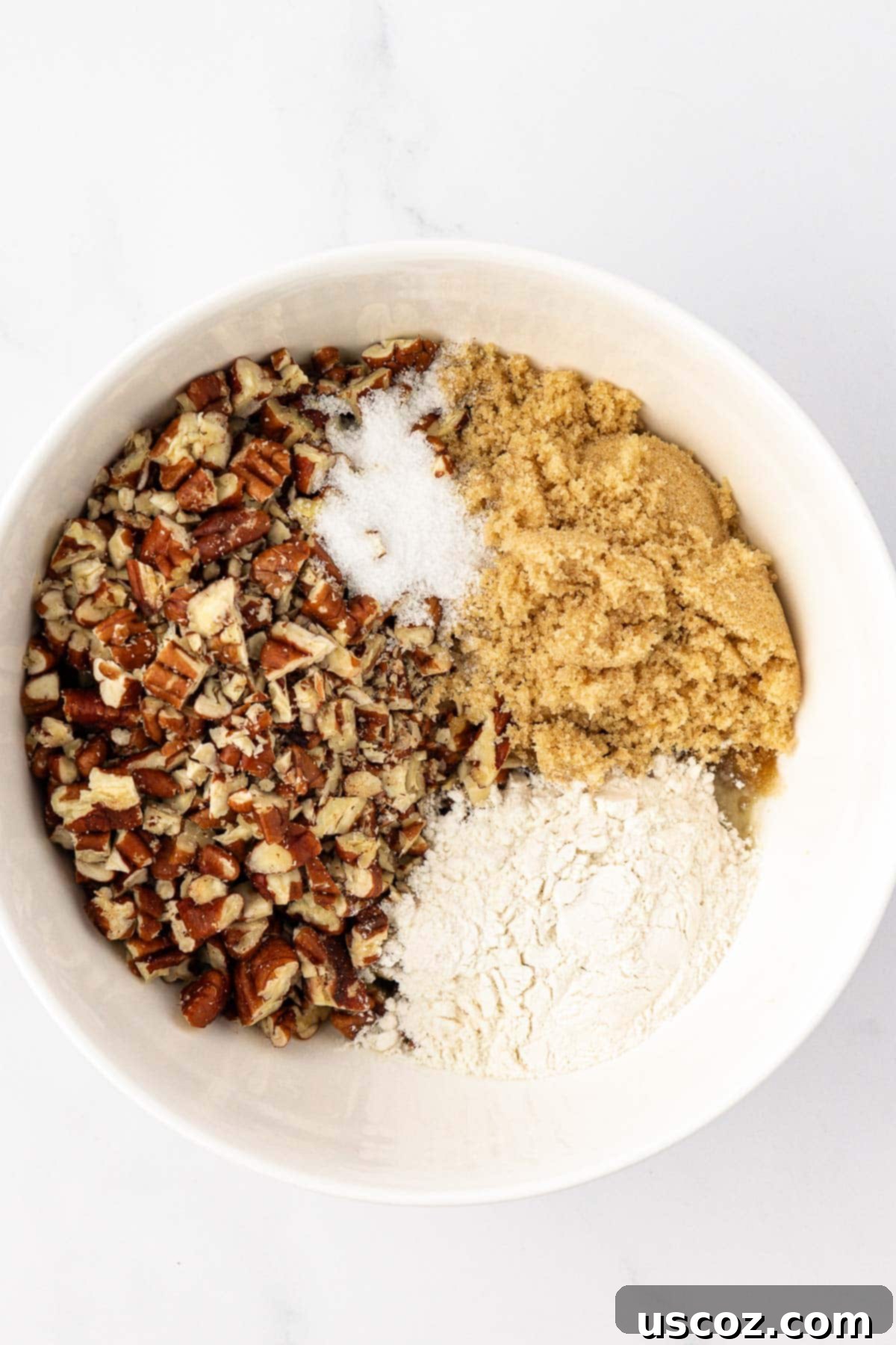 Golden Sweet Potato & Pecan Delight 9 Melted butter, brown sugar, flour, and salt being actively mixed in a bowl, forming the base for the crunchy pecan crumble topping.