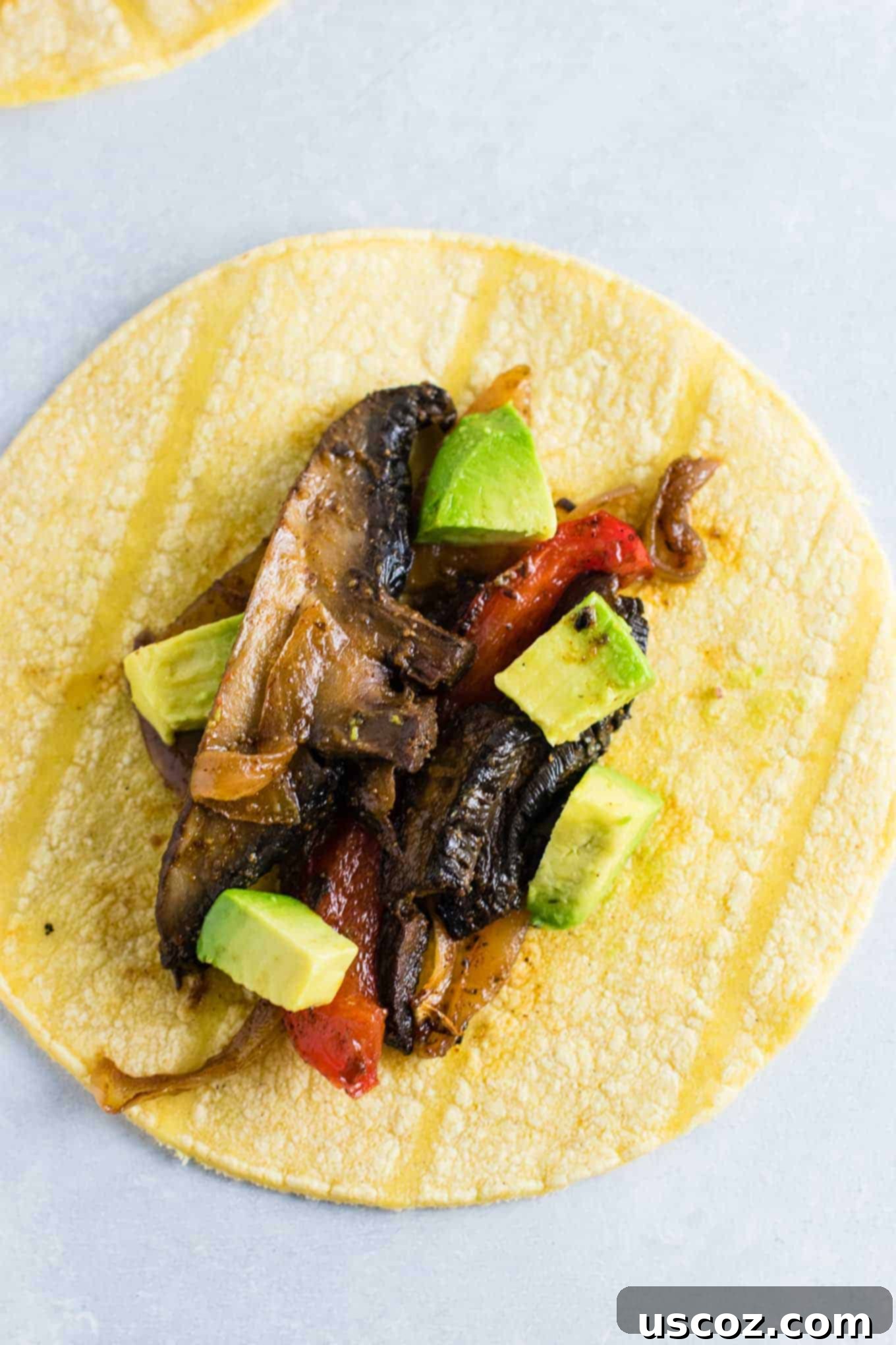 Sizzling Portobello Fajitas 3 mushroom fajitas on a corn tortilla with diced avocado