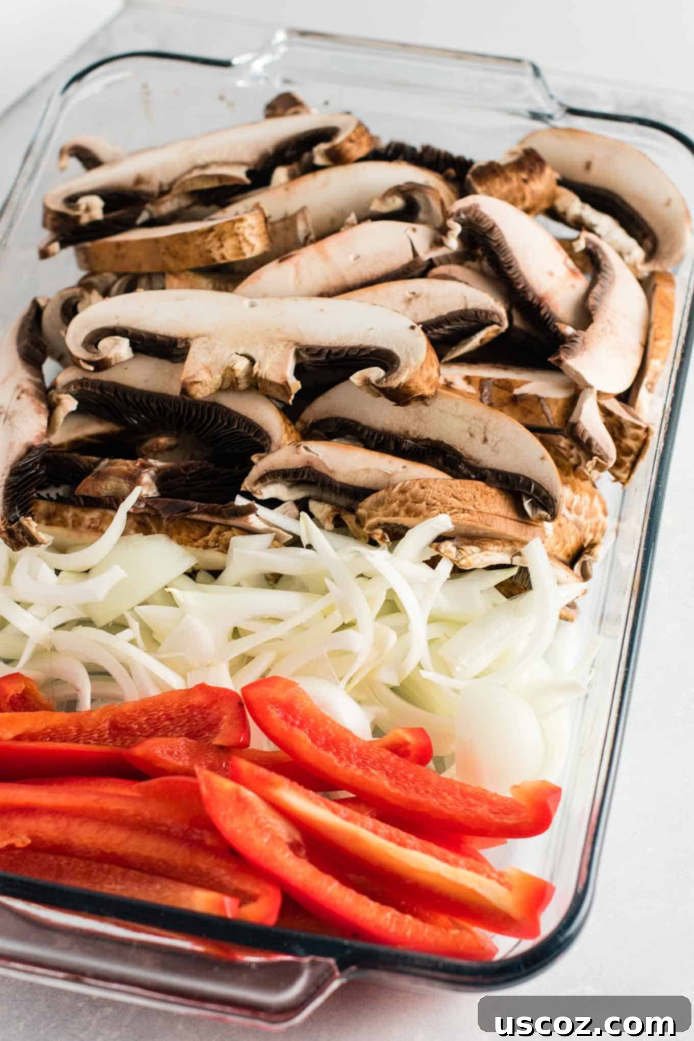 Sizzling Portobello Fajitas 4 sliced portobello mushroom caps, onion, and red bell pepper in a glass baking dish