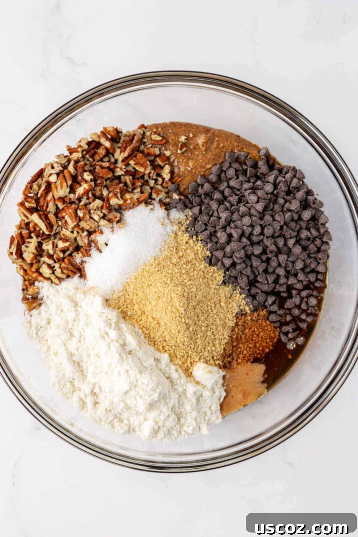 Pecan Pie Power Bites 5 pecan pie energy bite ingredients in a mixing bowl before combining