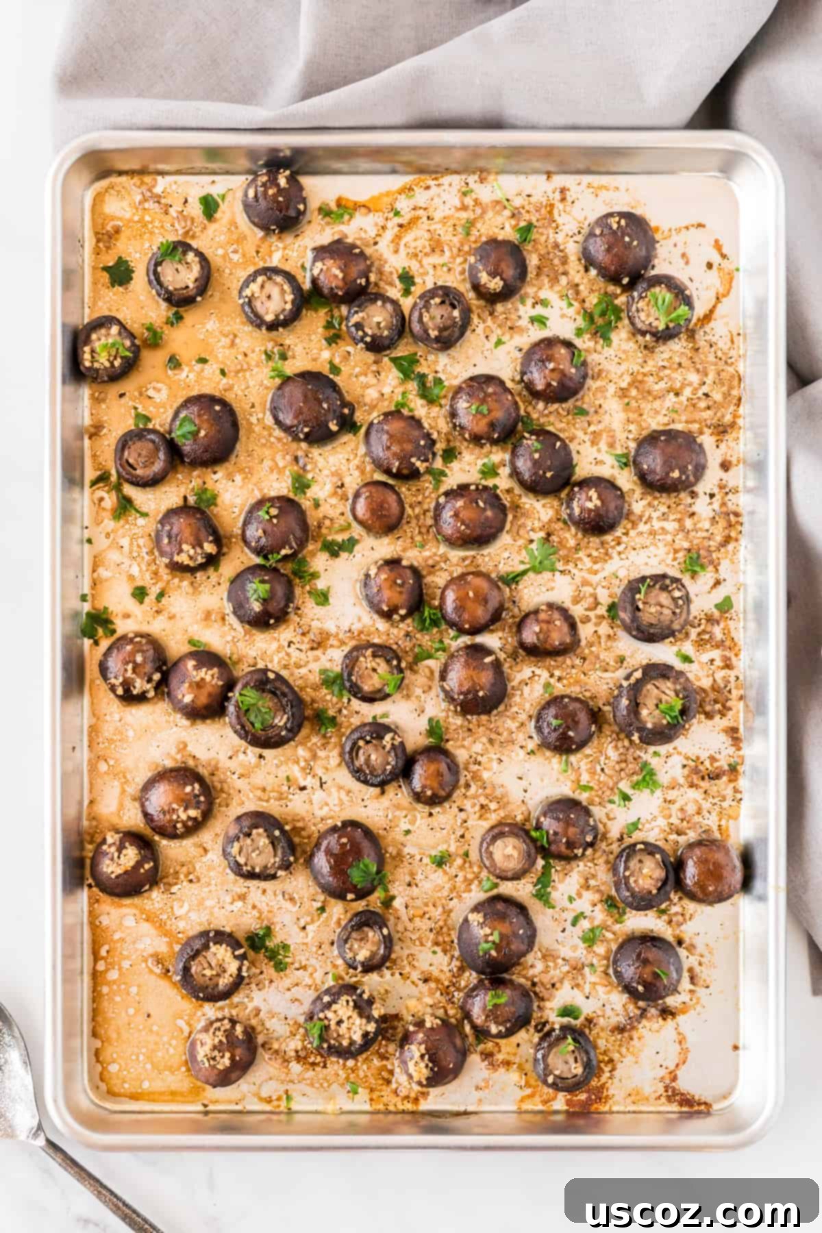 Garlicky Roasted Mushrooms 5 roasted garlic mushrooms on a sheet pan from an overhead view, ready to serve