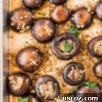 Garlicky Roasted Mushrooms 7 roasted garlic mushrooms on a sheet pan