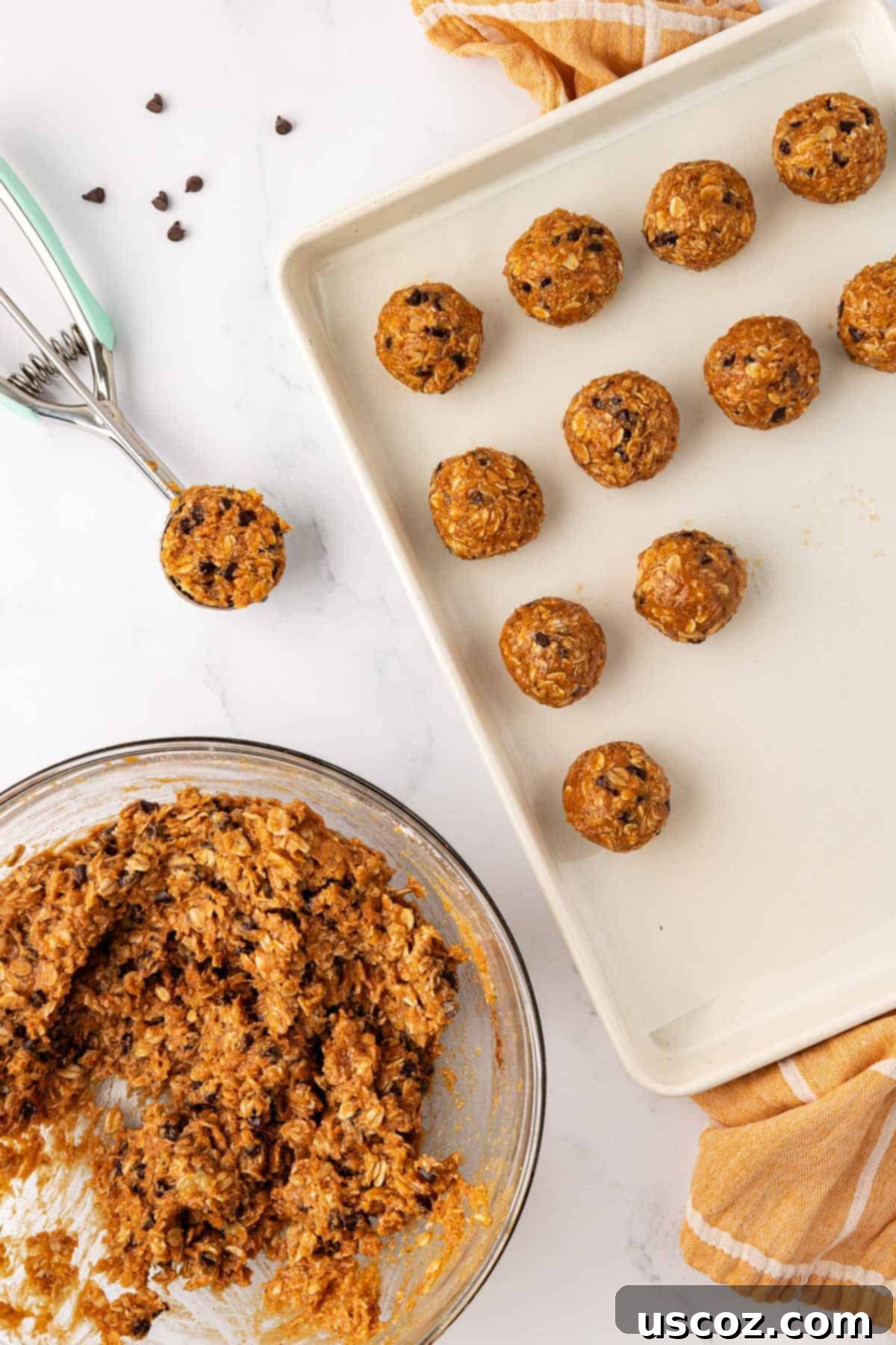 Banana Bread Energy Bites 7 Baking sheet with a scoop and unrolled energy bites