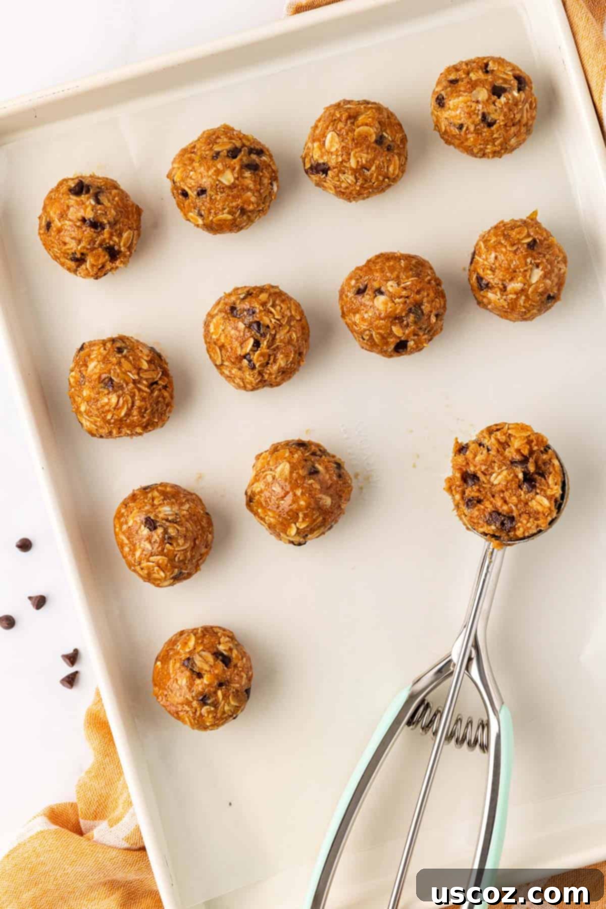 Banana Bread Energy Bites 8 Baking sheet with a scoop and rolled energy bites