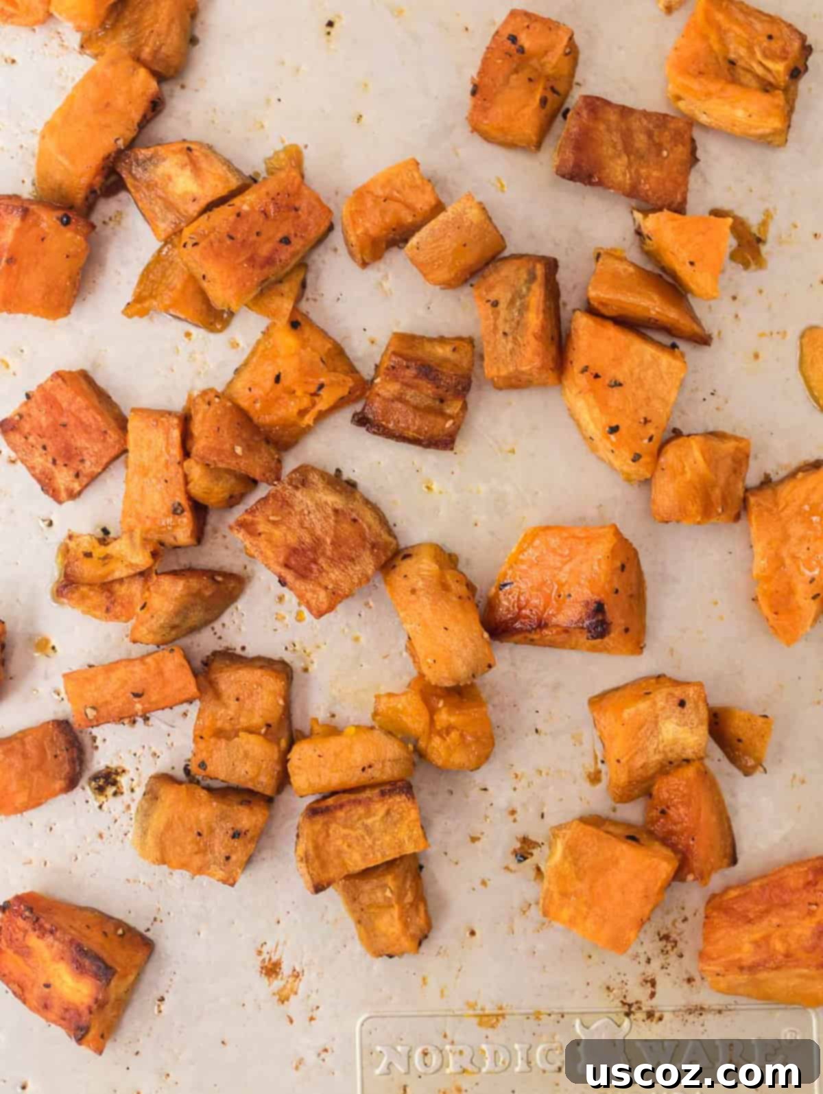 Golden Roasted Sweet Potato Bites 9 Perfectly roasted sweet potato cubes ready to be stored or served, highlighting their golden-brown finish.