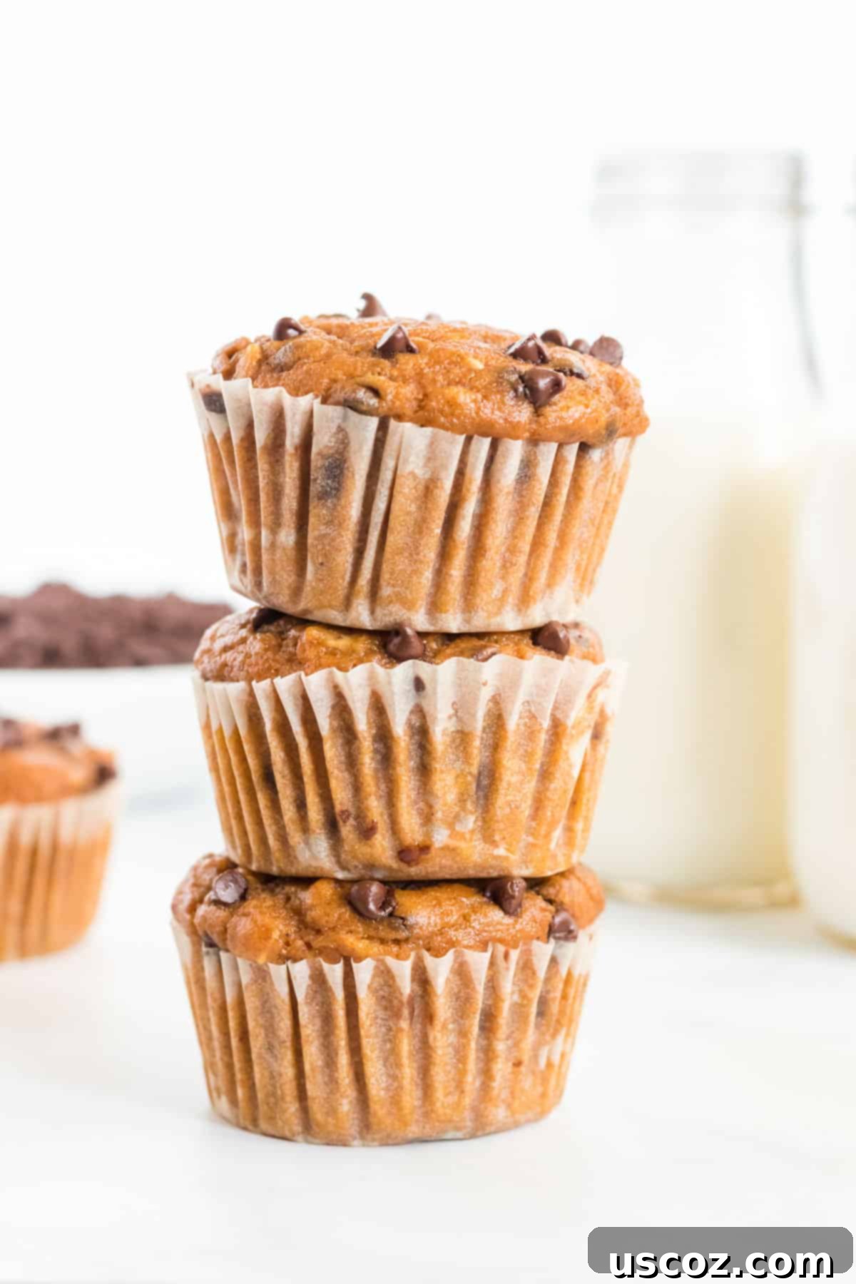 Guilt-Free Pumpkin Chocolate Chip Muffins 12 Stacked healthy pumpkin chocolate chip muffins, showing their fluffy texture