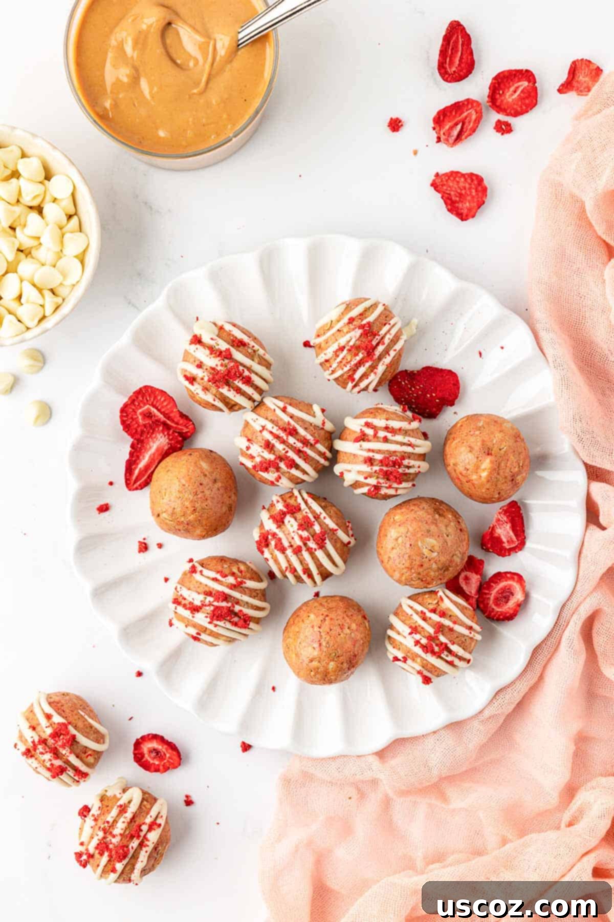 Strawberry Cream Energy Bites 13 strawberries and cream energy bites on a rustic wooden cutting board