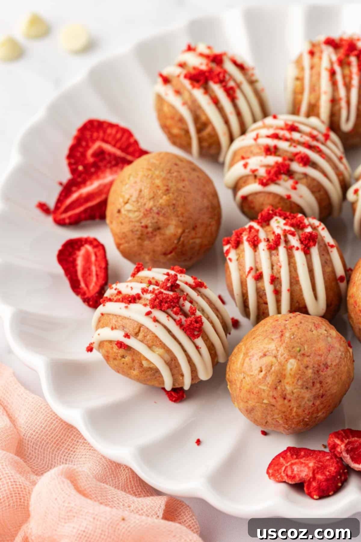 Strawberry Cream Energy Bites 3 close up of strawberries and cream energy bites with a bite taken out