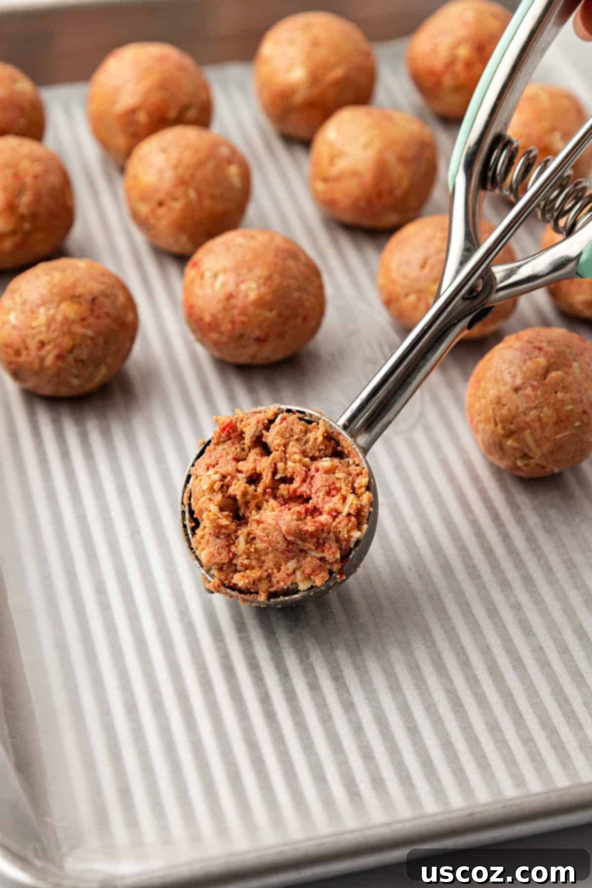 Strawberry Cream Energy Bites 8 mini cookie scoop filled with energy bite batter, ready for shaping